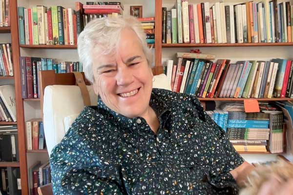 Patricia Spencer in front of bookcase