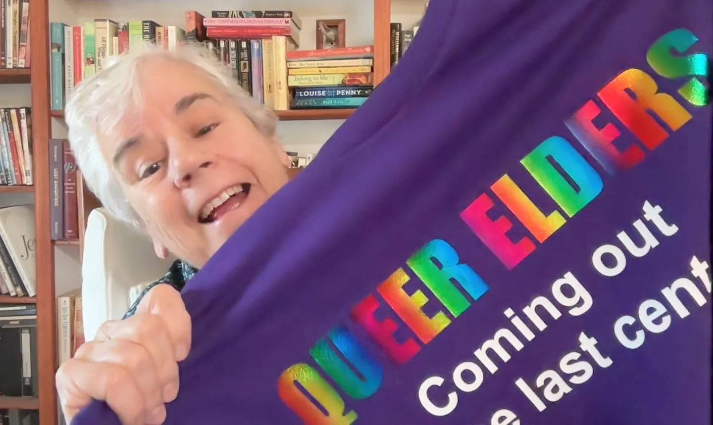 Patty holding Queer Elders T-shirt